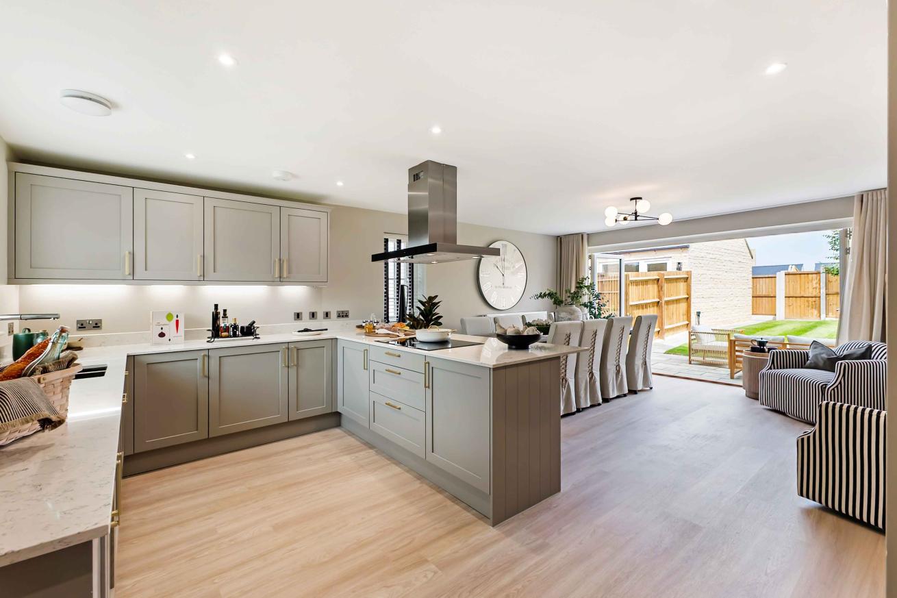 Kitchen diner finished with wooden floors and light appliances. 